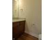 Small bathroom with granite countertop and wood cabinets at 513 N Park Ave, Indianapolis, IN 46202