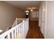 Upstairs hallway with hardwood floors and white railing at 513 N Park Ave, Indianapolis, IN 46202