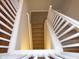 Carpeted staircase with white railing at 513 N Park Ave, Indianapolis, IN 46202