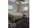 Bright bedroom with floral bedding and ceiling fan at 5708 N Keystone Ave, Indianapolis, IN 46220