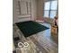 Living room with built-in shelving and green area rug at 5708 N Keystone Ave, Indianapolis, IN 46220