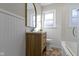 Updated bathroom with a light vanity, subway tile, and a new tub at 6023 Primrose Ave, Indianapolis, IN 46220