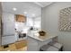 Modern kitchen with white cabinets, granite countertops, and a wood range hood at 6023 Primrose Ave, Indianapolis, IN 46220