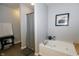 Bathroom with a soaking tub, stylish fixtures, and neutral walls at 6595 Reserve Dr, Indianapolis, IN 46220
