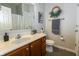 Bright bathroom featuring a marble countertop, wood cabinet, and decorative wreath over towel rack at 6595 Reserve Dr, Indianapolis, IN 46220