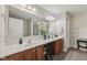 Bathroom featuring double sinks, a large mirror, vanity with decorative accessories and tile flooring at 6595 Reserve Dr, Indianapolis, IN 46220