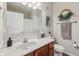 Bathroom featuring a vanity with marble countertops, wood cabinets, and a decorative wall hanging at 6595 Reserve Dr, Indianapolis, IN 46220