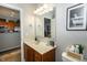 Bathroom with sleek vanity, stylish mirror, and view into the kitchen at 6595 Reserve Dr, Indianapolis, IN 46220