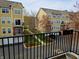 Views of apartment community featuring yellow apartments, manicured lawn, parking, and balcony at 6595 Reserve Dr, Indianapolis, IN 46220