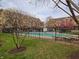 Community pool with surrounding wrought iron fence and landscaping viewed from community lawn at 6595 Reserve Dr, Indianapolis, IN 46220