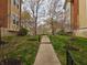 Community sidewalk with manicured lawn, walking path, and mature trees in a serene outdoor setting at 6595 Reserve Dr, Indianapolis, IN 46220