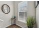 Charming entryway with a round mirror, accent table, and large window at 6595 Reserve Dr, Indianapolis, IN 46220