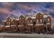 Beautiful brick townhomes with snow-covered roofs and charming front yard fences creating an inviting curb appeal at 6595 Reserve Dr, Indianapolis, IN 46220