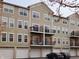 Back exterior of condo showcasing balconies above attached garages, providing convenient parking and outdoor space at 6595 Reserve Dr, Indianapolis, IN 46220