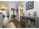 Hallway with modern decor, leading to the dining room and bathroom, featuring a stylish bar area at 6595 Reserve Dr, Indianapolis, IN 46220