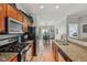 The kitchen features stainless steel appliances, granite countertops, and a view to the open concept living area at 6595 Reserve Dr, Indianapolis, IN 46220