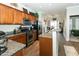 Well-lit kitchen featuring stainless steel appliances, granite countertops, wooden cabinets and an open design that flows into the dining area at 6595 Reserve Dr, Indianapolis, IN 46220