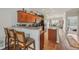 Open-concept kitchen featuring granite countertops, wooden cabinetry and stainless steel appliances with bar stool seating at 6595 Reserve Dr, Indianapolis, IN 46220