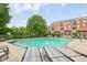 Community pool surrounded by lounge chairs and lush greenery, perfect for relaxation and recreation at 6595 Reserve Dr, Indianapolis, IN 46220