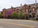 Brick townhomes lined street with vibrant trees, black iron fences, and well-maintained landscaping at 6595 Reserve Dr, Indianapolis, IN 46220