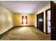 Empty bedroom with yellow walls and golden carpet at 7517 E Stop 11 Rd, Indianapolis, IN 46259