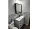 Updated bathroom with white vanity, gray leaf wallpaper, and modern fixtures at 81 Middleton Rd, Franklin, IN 46131