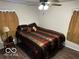 King-size bed in a well-lit bedroom with dark wood accents at 81 Middleton Rd, Franklin, IN 46131