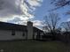 House backyard with deck and trees under a cloudy sky at 9120 Jene Ct, Indianapolis, IN 46234