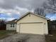 Attached garage with beige siding and a brown roof at 9120 Jene Ct, Indianapolis, IN 46234