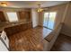 Eat-in kitchen with wood cabinets, laminate floor, and access to deck at 9120 Jene Ct, Indianapolis, IN 46234