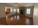 Spacious living room featuring hardwood floors, a stone fireplace, and an open kitchen view at 9120 Jene Ct, Indianapolis, IN 46234