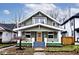 Charming two-story house with a green exterior, white trim, and a welcoming front porch at 926 N Dearborn St, Indianapolis, IN 46201