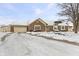 Brick ranch home with attached garage and snow-covered yard at 10 Sycamore Ct, Brownsburg, IN 46112