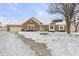 Brick ranch home with attached garage and snow-covered yard at 10 Sycamore Ct, Brownsburg, IN 46112