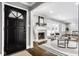 Bright and airy entryway with a black door and view into the living room at 101 E 96Th St, Indianapolis, IN 46240