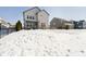 Large backyard with snow covering the ground and a two-story home at 10500 Sanford Ct, Fishers, IN 46040