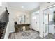 Bright entryway with wood-like flooring, large mirror, and rustic console table at 10500 Sanford Ct, Fishers, IN 46040