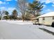 Backyard patio with snow, fire pit, and tree in the background at 1060 Stringtown Pike, Cicero, IN 46034