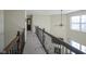 Upstairs hallway with carpeted floor and dark wood railings at 10963 Field Crescent Cir, Noblesville, IN 46060