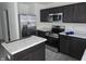 Modern kitchen featuring stainless steel appliances and dark cabinetry at 11027 Walter Dr, Indianapolis, IN 46235