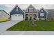 Two-story home with blue siding, white trim, and a landscaped lawn at 1319 Clairet Dr, Westfield, IN 46074