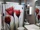 Clean bathroom with updated vanity and red floral shower curtain at 13952 Avalon Blvd, Fishers, IN 46037