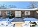 Front entry with double doors, brick facade, and snow covered landscaping at 1619 Beech Cir, Plainfield, IN 46168