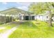 Spacious backyard featuring a covered carport, and a fire pit area, perfect for outdoor entertainment at 1704 Nelson Ave, Indianapolis, IN 46203