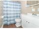 Bathroom with white vanity, shower, and blue striped curtain at 1704 Nelson Ave, Indianapolis, IN 46203