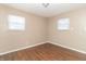 Spacious bedroom with two windows and wood-look floors at 1704 Nelson Ave, Indianapolis, IN 46203