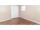 Bedroom with closet and window, featuring wood-look floors at 1704 Nelson Ave, Indianapolis, IN 46203