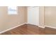 Bedroom with closet and window, featuring wood-look floors at 1704 Nelson Ave, Indianapolis, IN 46203