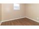 Simple bedroom with window and wood-look floors at 1704 Nelson Ave, Indianapolis, IN 46203