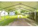 View under the carport showing a storage shed, driveway, and back yard at 1704 Nelson Ave, Indianapolis, IN 46203